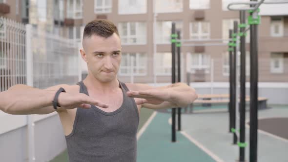 Man is Exercising at Open Air Gym