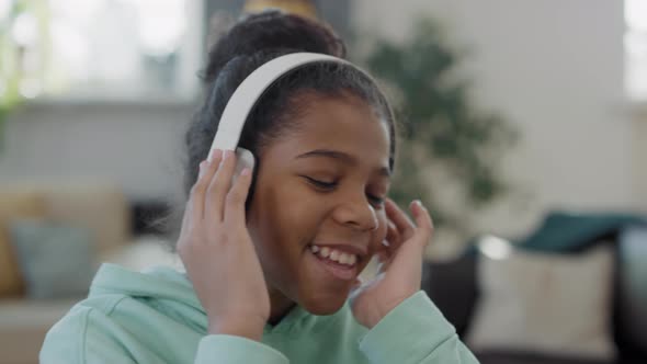 Close Up Of Afro Girl Listening To Music