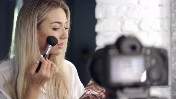 European Blond Beautiful Makeup Artist Is Doing Contouring
