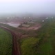 Aerial Flying on Oil Pumps at Oilfield Cluster in a Foggy Field After Rain - VideoHive Item for Sale