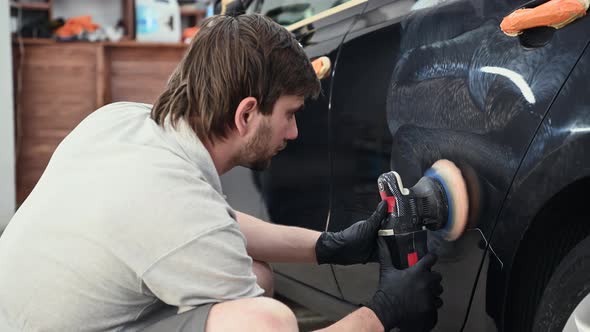 Car Detailing  Hands with Orbital Polisher in Auto Repair Shop
