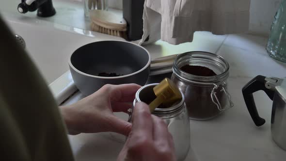 Woman make a coffee in moka pot in kitchen