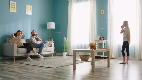 Family Has Fun Using Paper Cup Phone