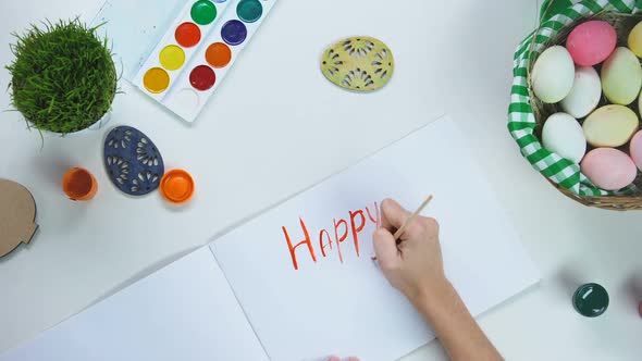 Female Hand Writing Happy Easter Greeting With Brush in Album, Holiday Card