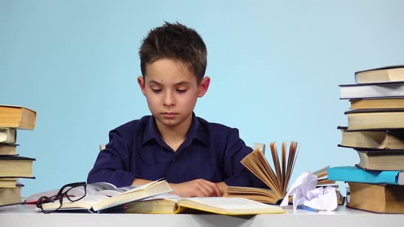 Tired Boy Begins To Close and Fold the Book. Blue Background