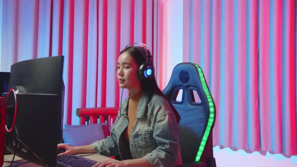 Young Asian Gamer Girl Start Playing Video Game On Computer