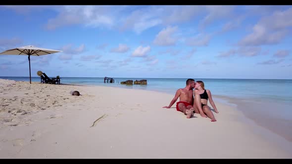 Guy and girl in love on marine coast beach lifestyle by turquoise ocean and white sand background of