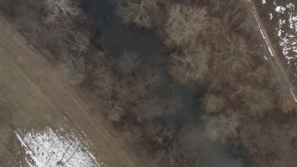 Ascending over Timok river flow by winter 4K aerial video