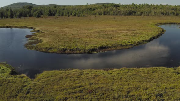 Aerial shot approaching meandering Union River, Eastern Maine