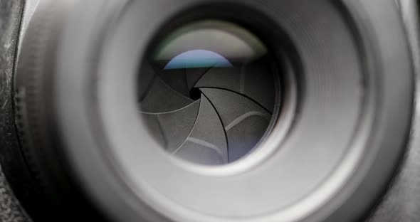 Closeup shot of professional camera lens, adjusting aperture