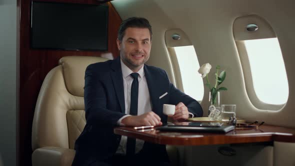 Smiling Ceo Posing Alone at Airplane Window