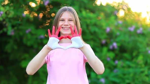 Kid Hands in Heart Form Painted in Flag Monaco or Indonesia Focus on Hands