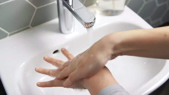 Close Up of Woman Washing Hands with Liquid Soap