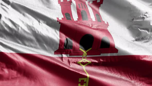 Gibraltar textile flag waving on the wind. Slow motion. 20 seconds loop.