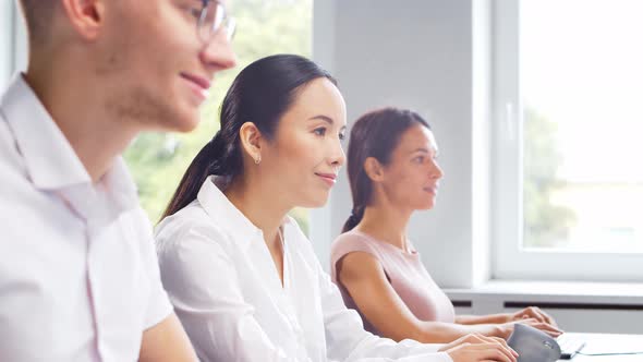 Diverse team of young professionals is working in the phone support office.