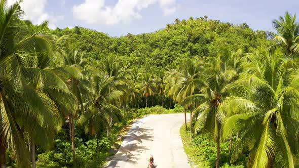 Young Beautiful Couple Rides the Jungle on a Scooter, Travel, Freedom, Happiness, Vacation