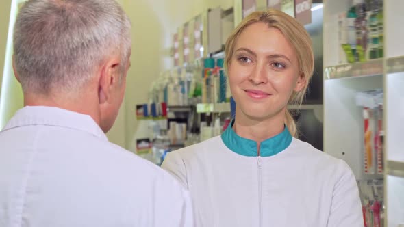 Female Chemist Smiling Joyfully Talking To Her Senior Colleague