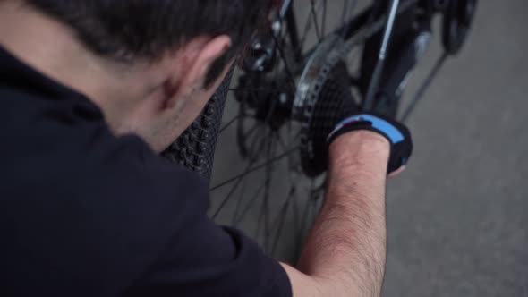 the guy repairs the bike. bike breakdown. breakdown on the road.