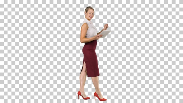 Woman walking using digital tablet and talking to camera