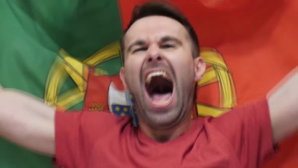 Portuguese Fan Celebrates Holding the Flag of Portugal