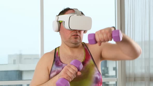 Overweight Sporty Man Doing a Weight Training Exercise By Using Dumbbell and Virtual Reality