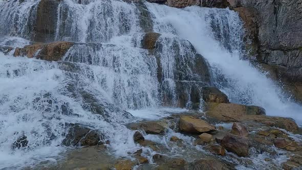 Waterfall flowing in slow motion panning down stream in Wyoming