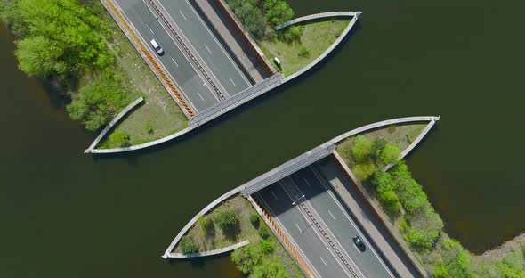 Highway traffic under Aquaduct Veluwemeer water bridge, Aerial view.