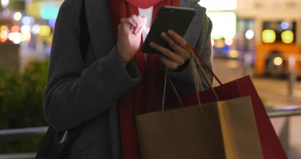 Young Woman use of smart phone in city at night