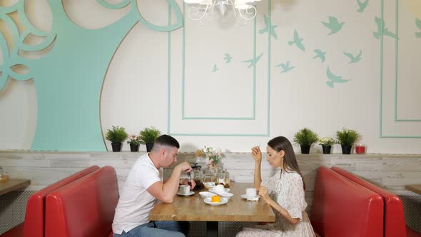 Lovely Family Spends Time Eating Cakes in Confectionery Shop