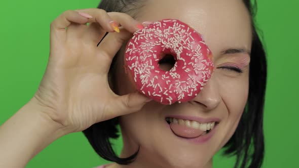 Happy Beautiful Young Girl Posing and Having Fun with Donut. Chroma Key