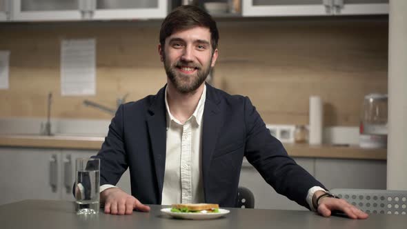 Portrait of Bearded Caucasian Man 20s Wearing Business Suit Smiling and Looking Happily While Having