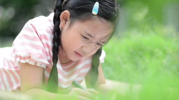 Cute Asian Child Drawing Picture With Crayon