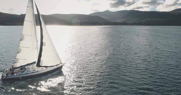 Sun Over Yacht at Ocean Coast Aerial alt