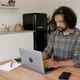 An Indian Freelancer Works behind a laptop at Home in A Bright Room, Creates A New Project - VideoHive Item for Sale
