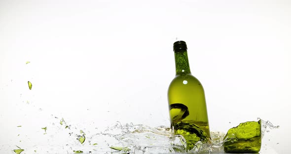 900135 Bottle of White Wine Breaking and Splashing against White Background, Slow motion 4K