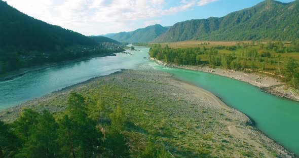 Low Altitude Flight Over Fresh Fast Mountain River with Rocks at Sunny Summer Morning