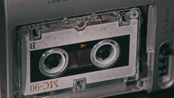 Audio Cassette in the Tape Recorder Playing and Rotates