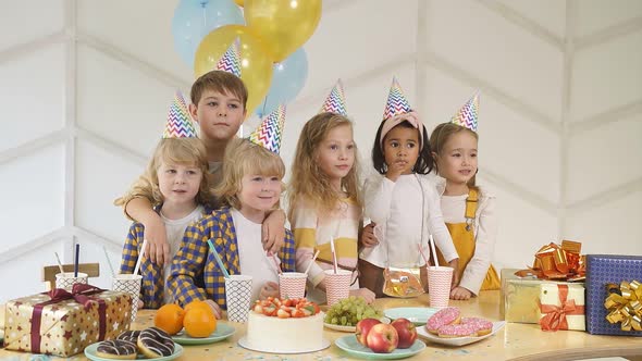 Happy Diverse Joyful Kids in Birthday Caps Celebrate Birthday