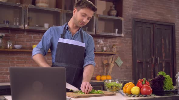 Male Cook Romantic Lunch Using Internet Indoors