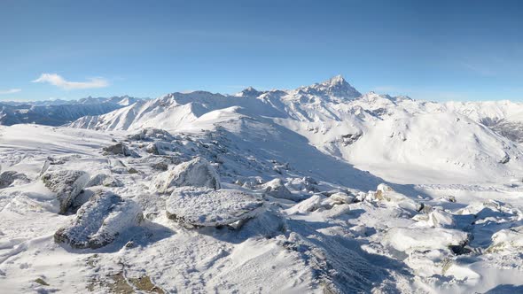 Panorama on snowcapped mountain peaks and ridges of the majestic italian Alps in winter