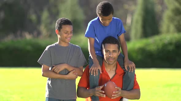 Group portrait of a father and his sons with a football