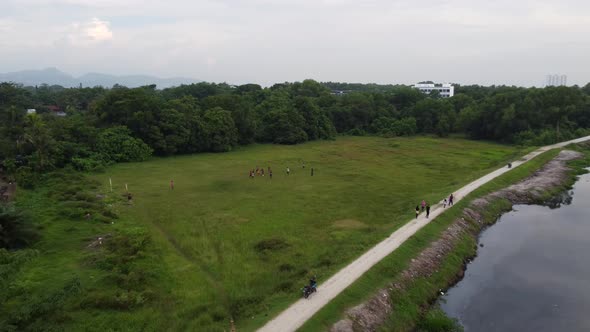 Aerial view group of child play football at green field