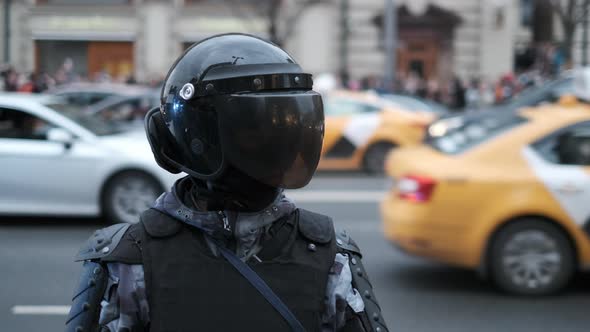 Police Officers in Protective Body Gear with Armor and Helmets Enforce Law