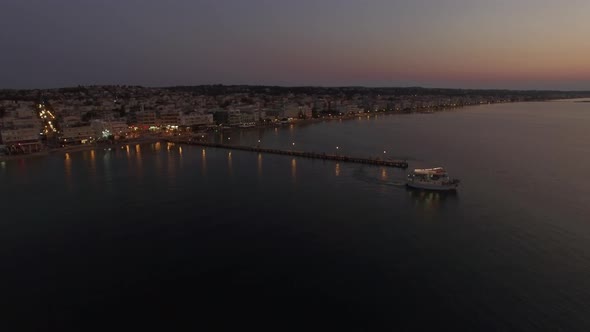 Flying over touristic boat in sea at night