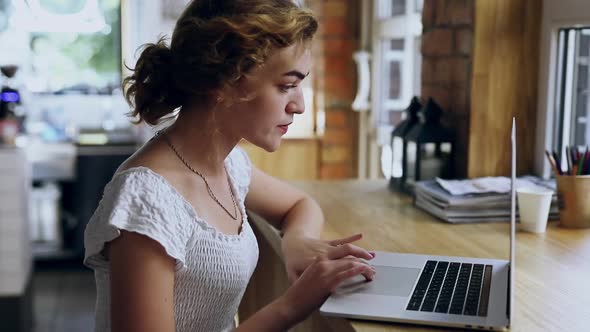 Young Woman Working By Laptop in a Coffee Shop