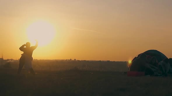 Plump Lady Silhouette Dances Under Orange Setting Sun