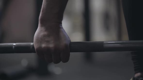 Male Caucasian Hand Raising Up and Putting Down Barbell. Unrecognizable Strong Sportsman Lifting