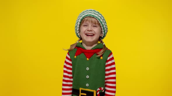 Kid Girl in Christmas Elf Santa Helper Costume Laughing Fooling Around