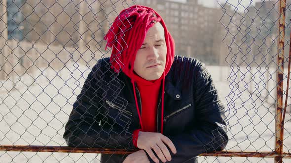 Stylish Man in Trendy Outfit and with Red Dreadlocks Standing on Street