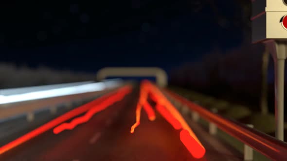 Moving Light Streaks On The Highway Next To The Flashing Radar Street Trap